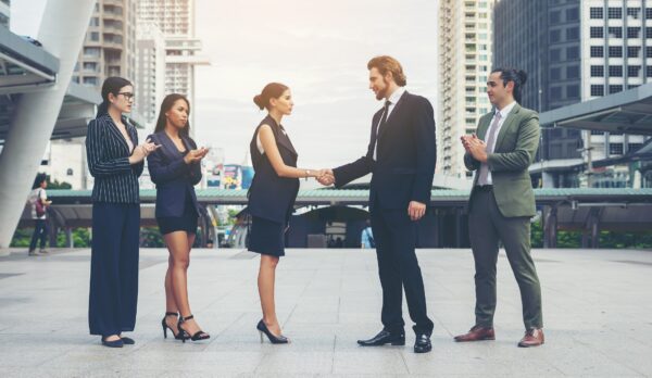 Happy business people shaking hands. Business success.