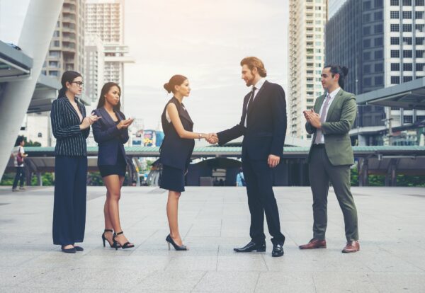 Happy business people shaking hands. Business success.