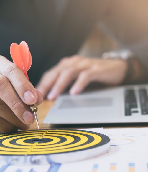 Businessman holding red dart push on target. Business strategy planning success target goals. Business development concept