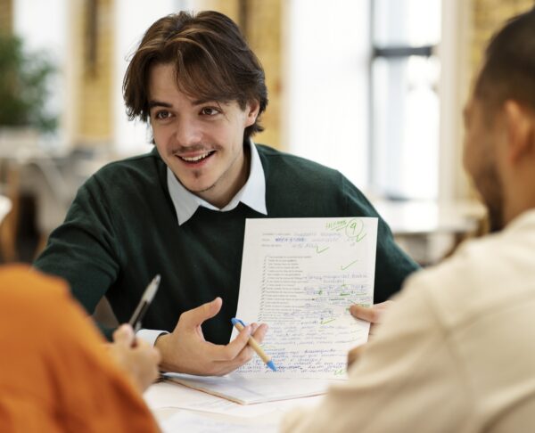 front-view-smiley-man-holding-paper-1